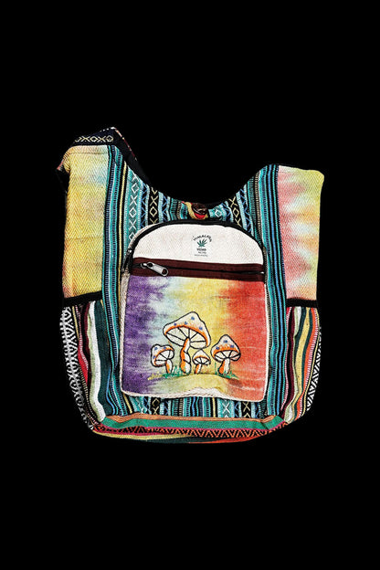 Handwoven shoulder bag with a psychedelic mushroom design, likely for carrying cannabis accessories.