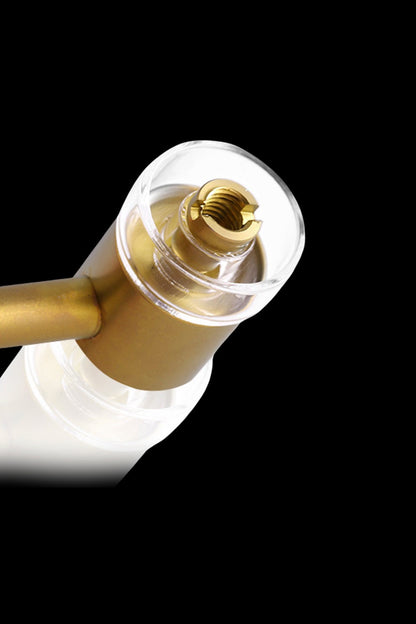 Close-up of a gold-toned cannabis oil applicator tip.
