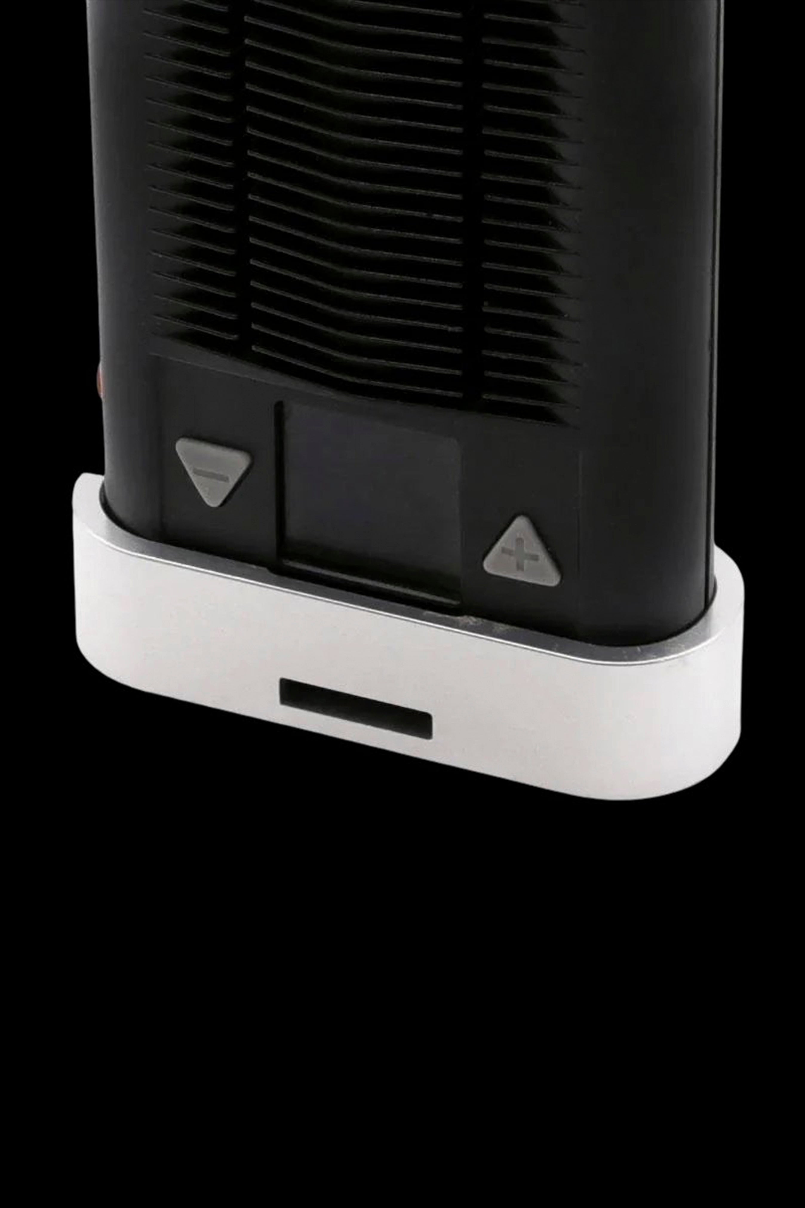 Close-up of the base of a sleek, black cannabis vaporizer with white accents and control buttons.