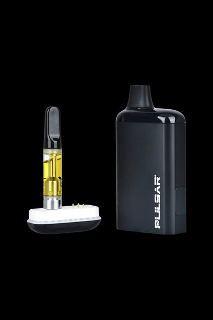 Black cannabis vape pen and cartridge with visible oil.