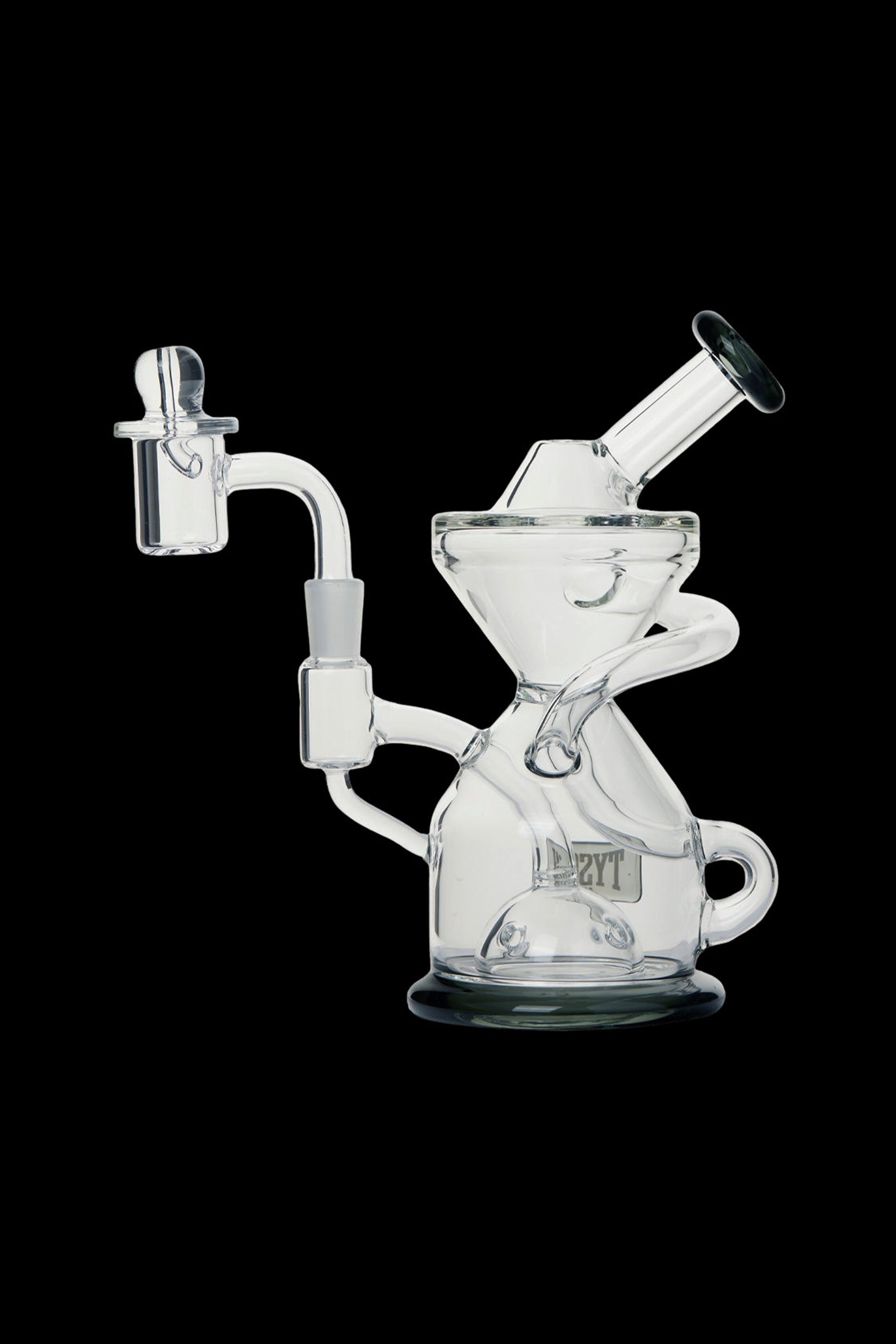 Clear glass dab rig with intricate curves and a quartz nail.