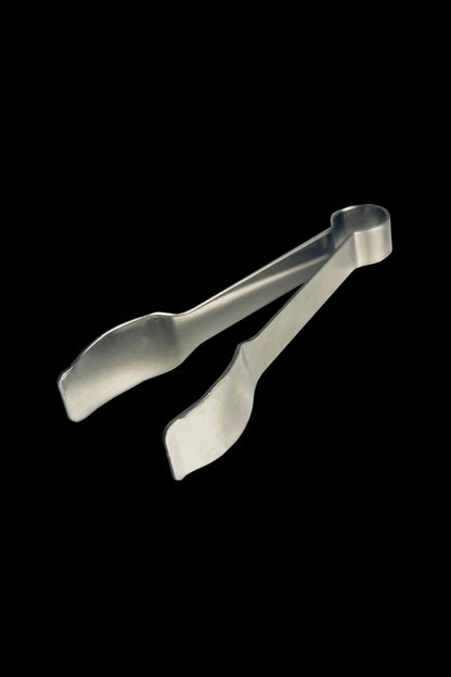 Clear cannabis handling tongs against a black background.