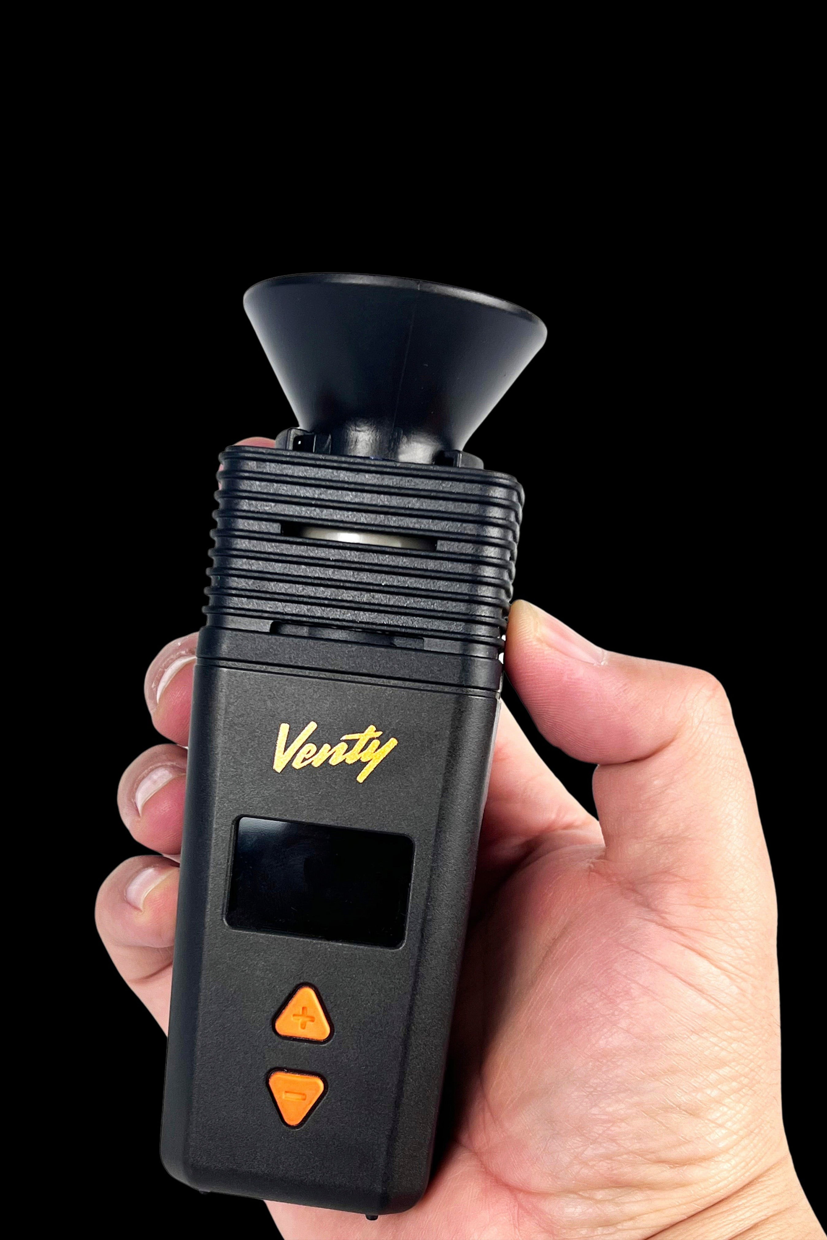 Close-up of a hand holding the black Venty Vaporizer Herb Funnel showing the flared mouthpiece, ribbed top section, and front buttons.