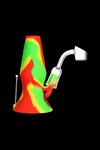 Colorful silicone rig with glass nail and dab tool.