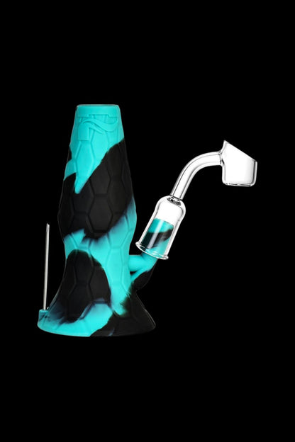 Blue and black silicone dab rig with a quartz banger and dab tool against a black background.