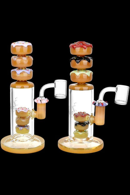 Two glass bongs with colorful donut-shaped percolators.