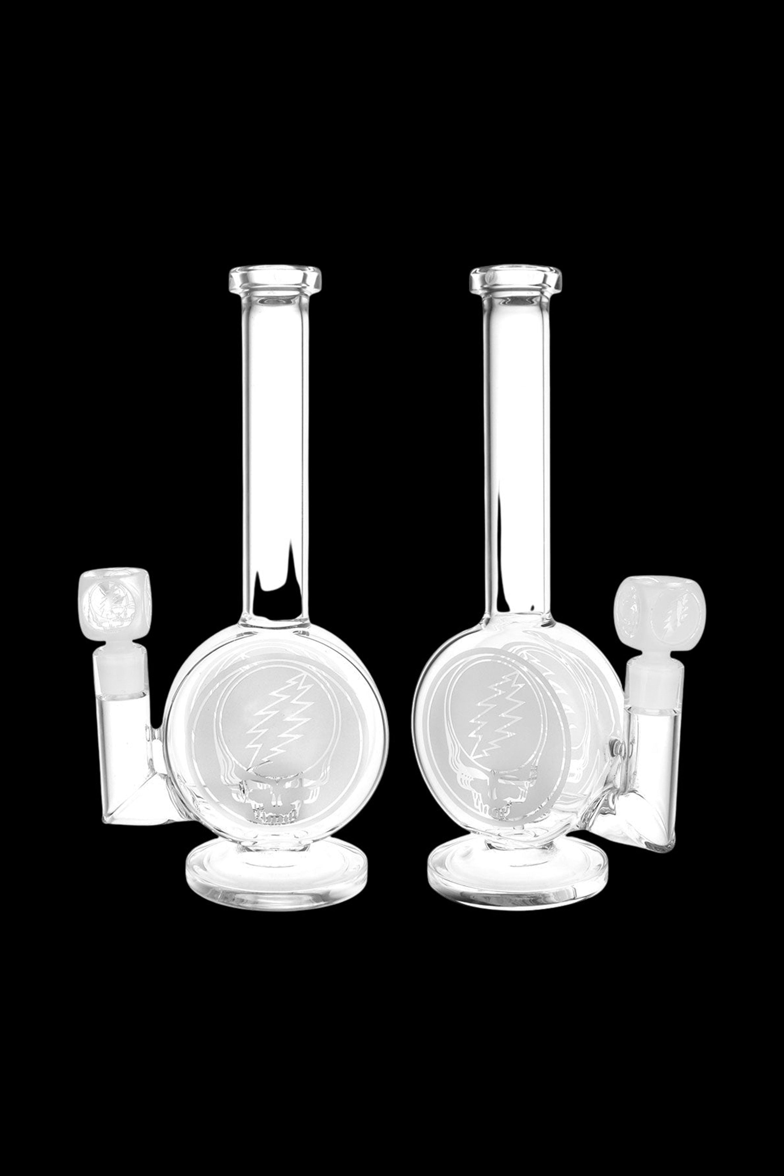 Two clear glass water pipes (bongs) against a black background.