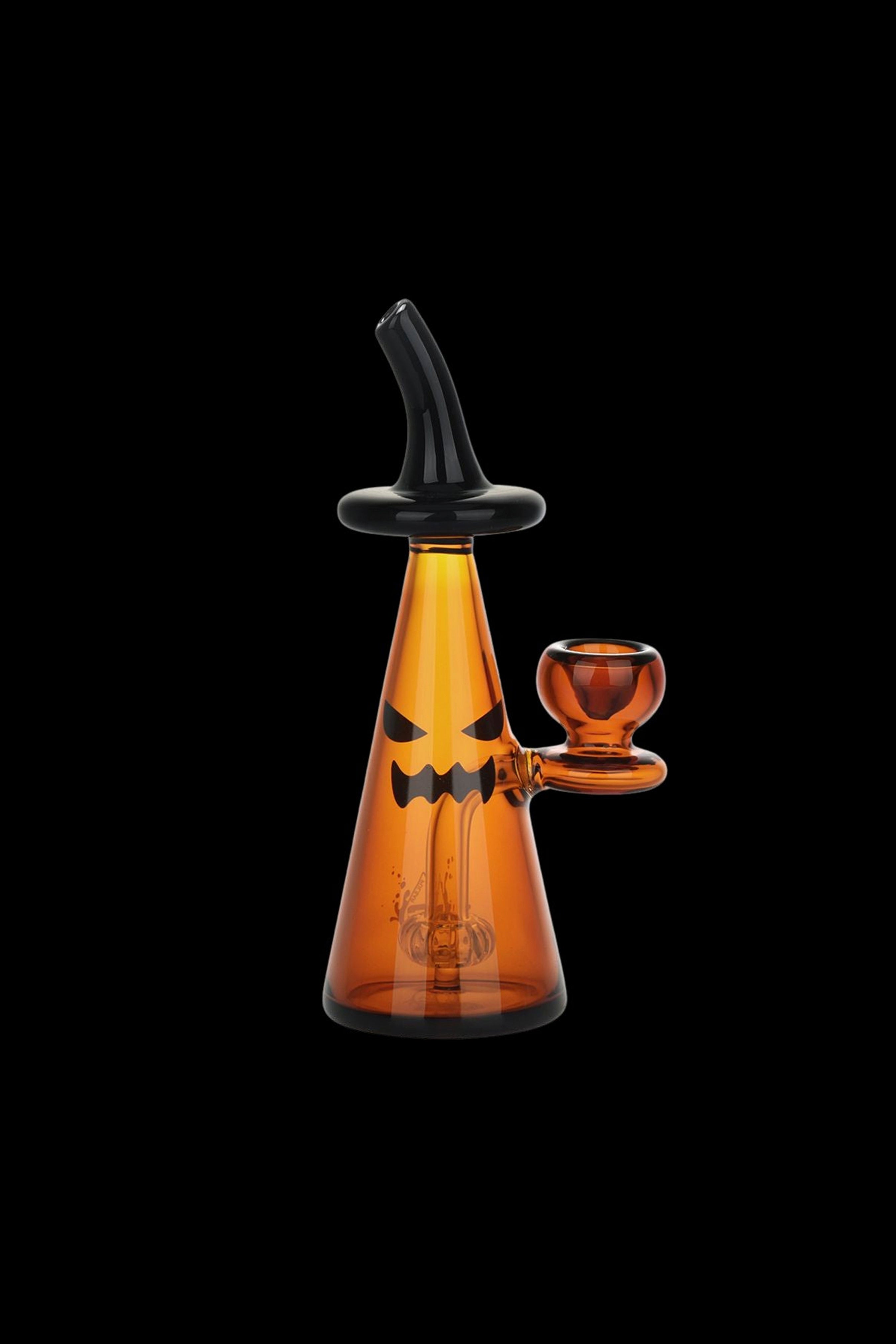 Orange glass water pipe shaped like a jack-o'-lantern with a black mouthpiece and base.