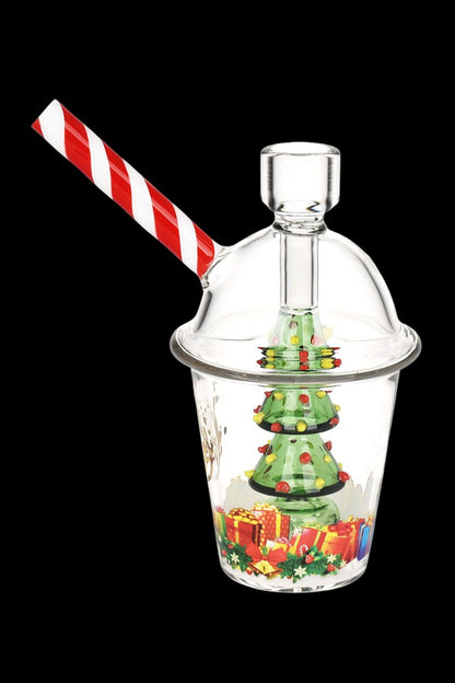 A glass bubbler shaped like a Christmas-themed snow globe with a candy cane straw.