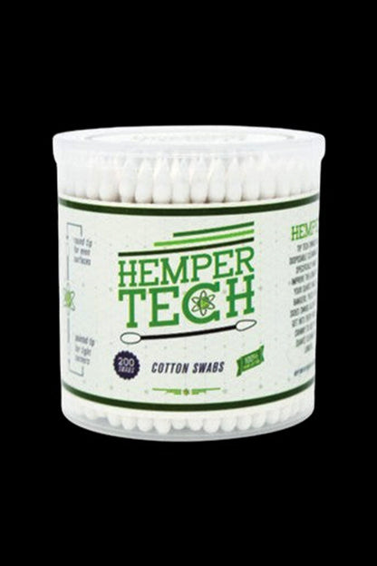 Close-up front view of a clear tub of Hemper Tech Cotton Buds 200ct showing white swab tips and green label text against black.