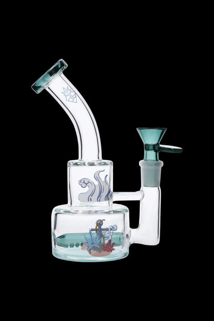Angled front view of the Cabana Cannabis Co. Ahoy Dab Rig - Teal showing its curved neck, teal bowl and nautical decal on clear glass