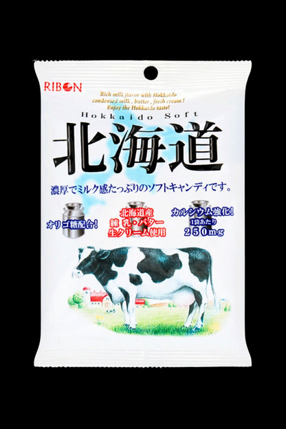A white candy wrapper featuring a Holstein cow and Japanese text, advertising “Hokkaido Soft” with a 250mg cannabis dosage indicated.