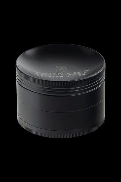 Black four-layer cannabis grinder with branded text.