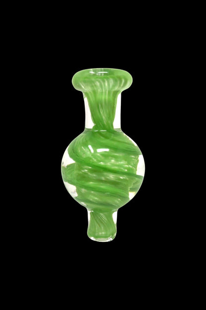 Green glass cannabis oil dome with white swirling patterns.