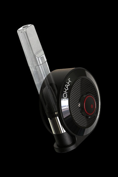 Sleek black and silver cannabis oil vaporizer pen with a clear cartridge, angled against a dark background.