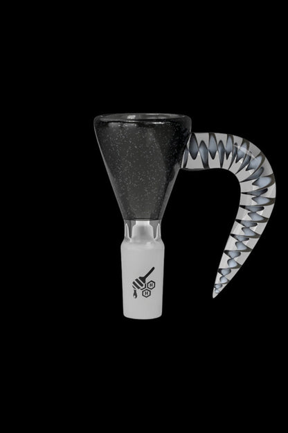 Black and white glass pipe with a patterned mouthpiece, isolated on a black background.