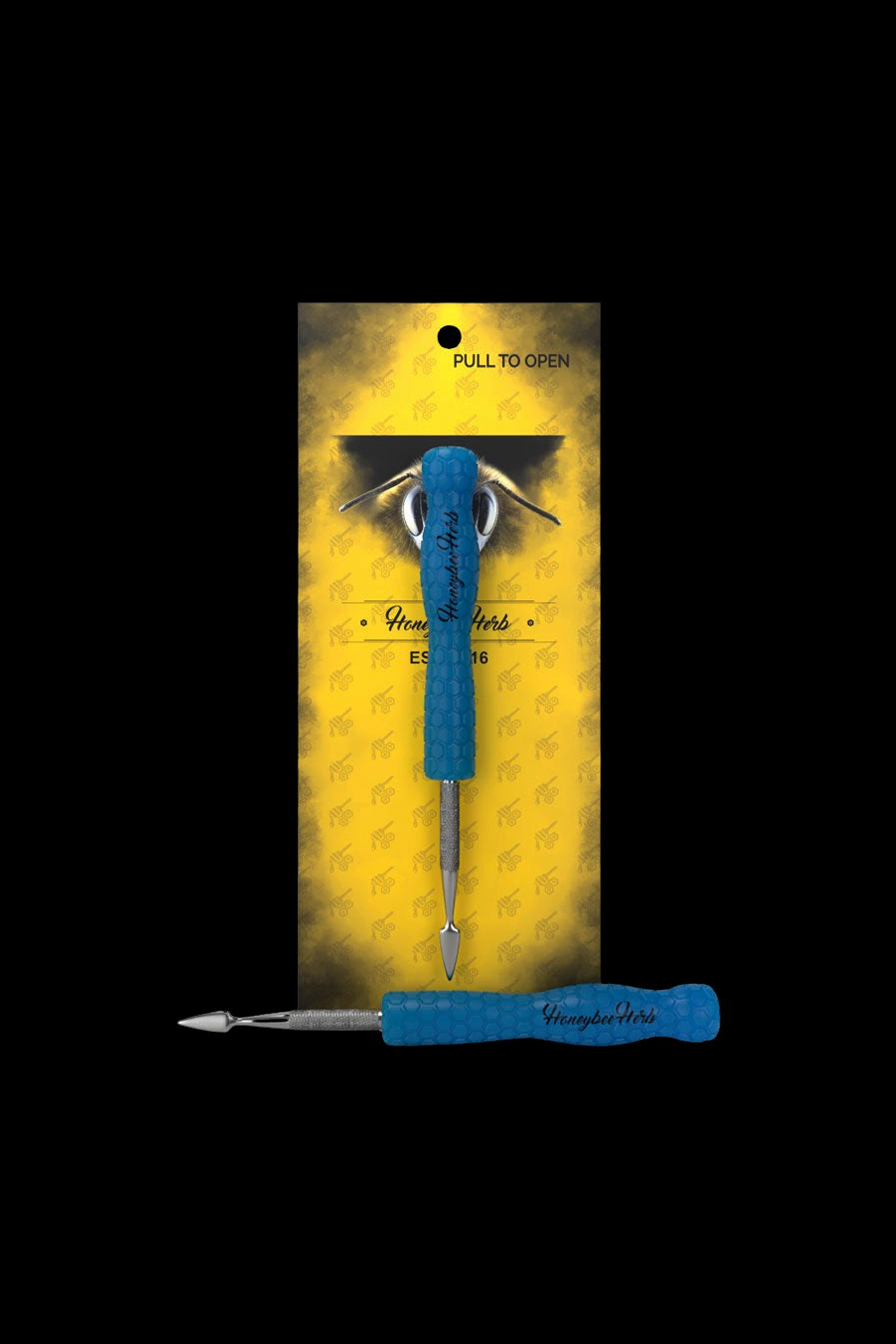 Blue cannabis dab tool in patterned packaging.