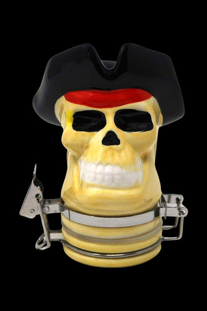 Pirate-themed glass bubbler with a skull design and metal clamps.