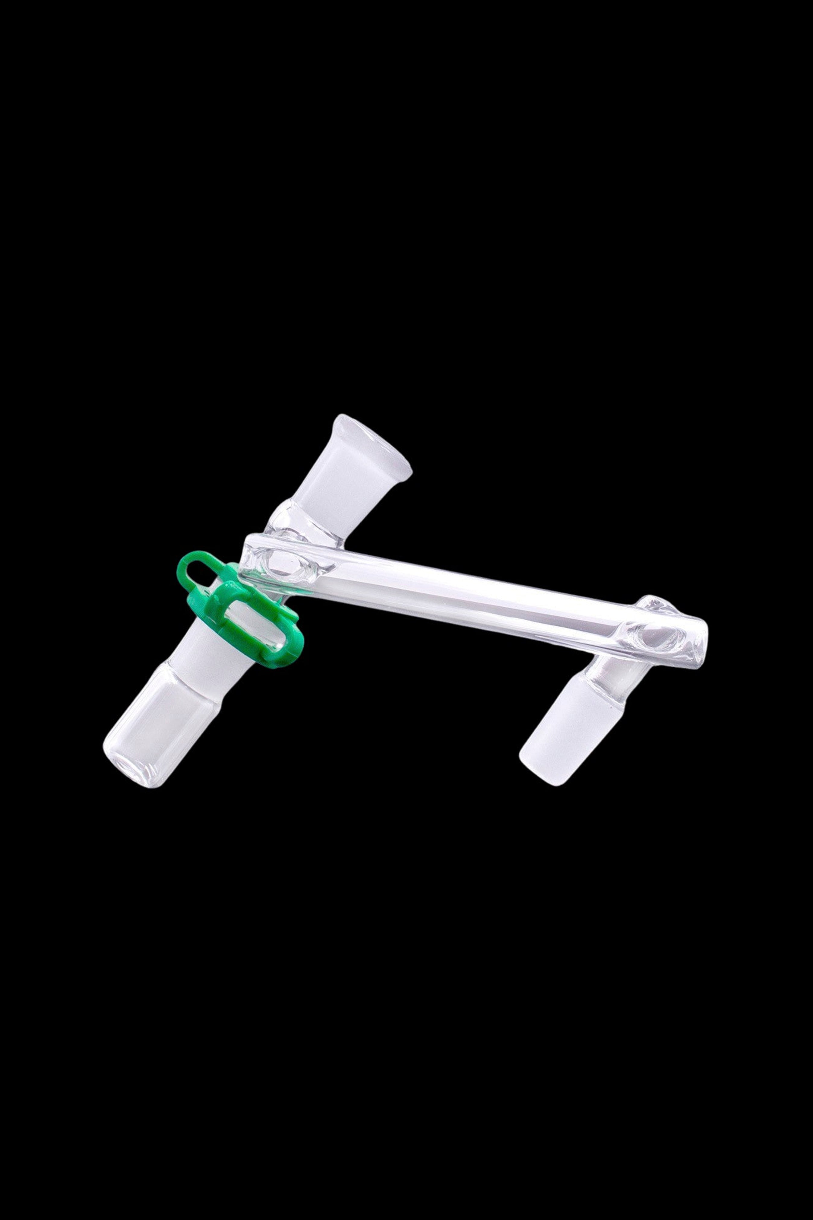 Clear glass cannabis adapter with green clip, isolated on black.