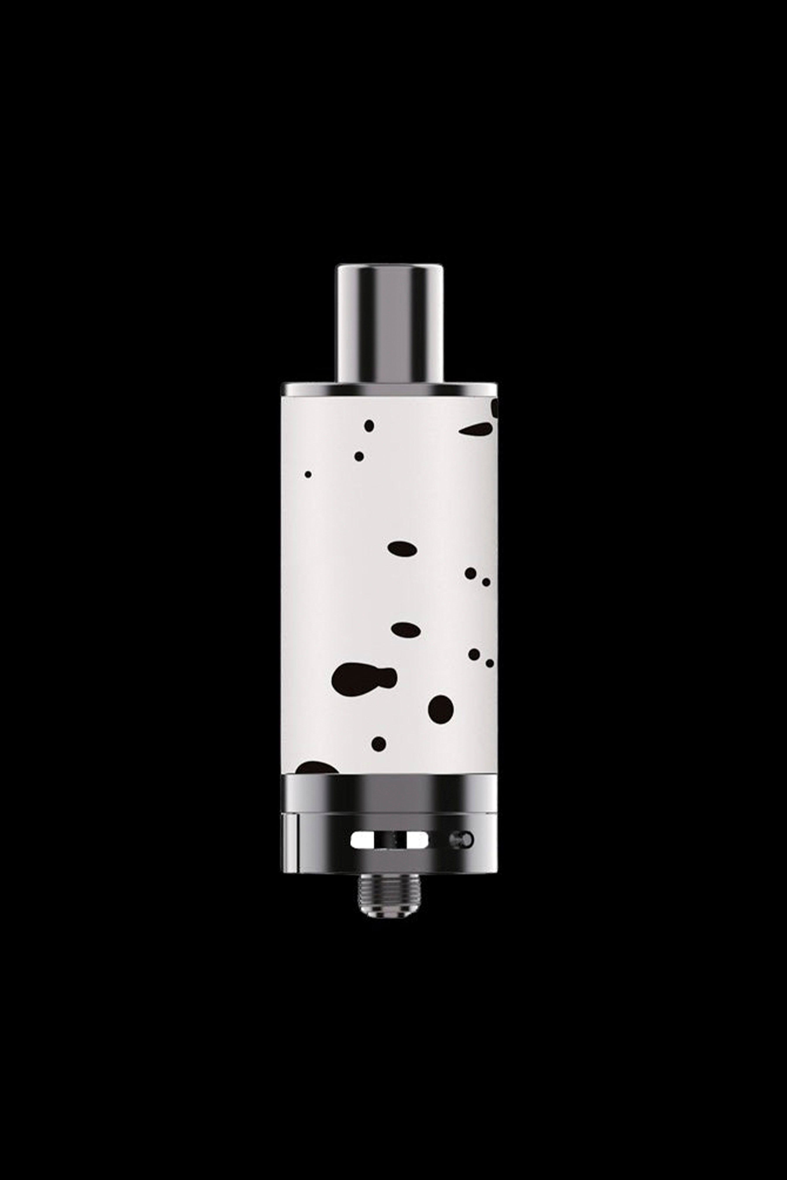 Silver cannabis oil vape cartridge with black speckles, isolated on a black background.