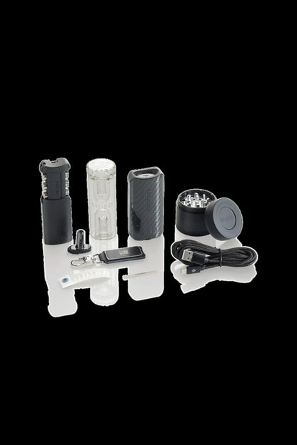 Cannabis vaporizer kit with device, bubbler attachment, charging cable, and accessories on a white background.
