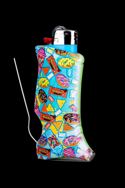 A colorful, patterned lighter sleeve depicting various snack foods like chips, donuts, and candy, covering a metallic lighter with a wire extension.