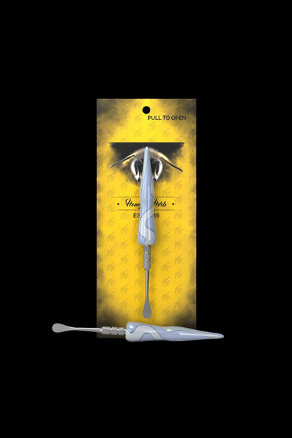 A packaged cannabis dab tool with a bee-themed design.