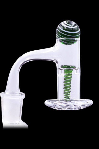 Clear glass oil rig carb cap with green accents.