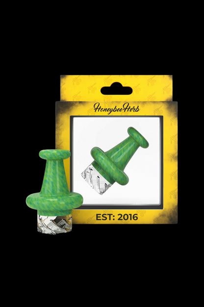 Close-up front view of a green Honeybee Herb Colorful Classic Vortex Carb Cap centered against its yellow product card, showing the cap's marbled finish and glass vortex tip.