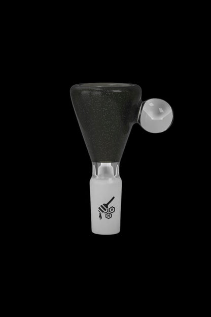 Glass cannabis bowl with black speckled interior and white branding.