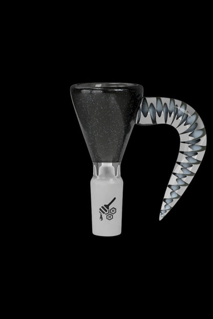 Black and white cannabis water pipe with a speckled bowl and patterned mouthpiece against a black background.
