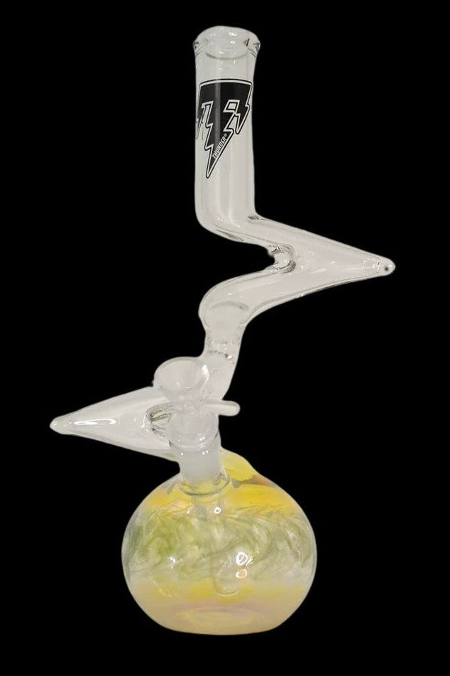 Clear glass water pipe (bong) with a rounded base containing yellow liquid and intricate glasswork.