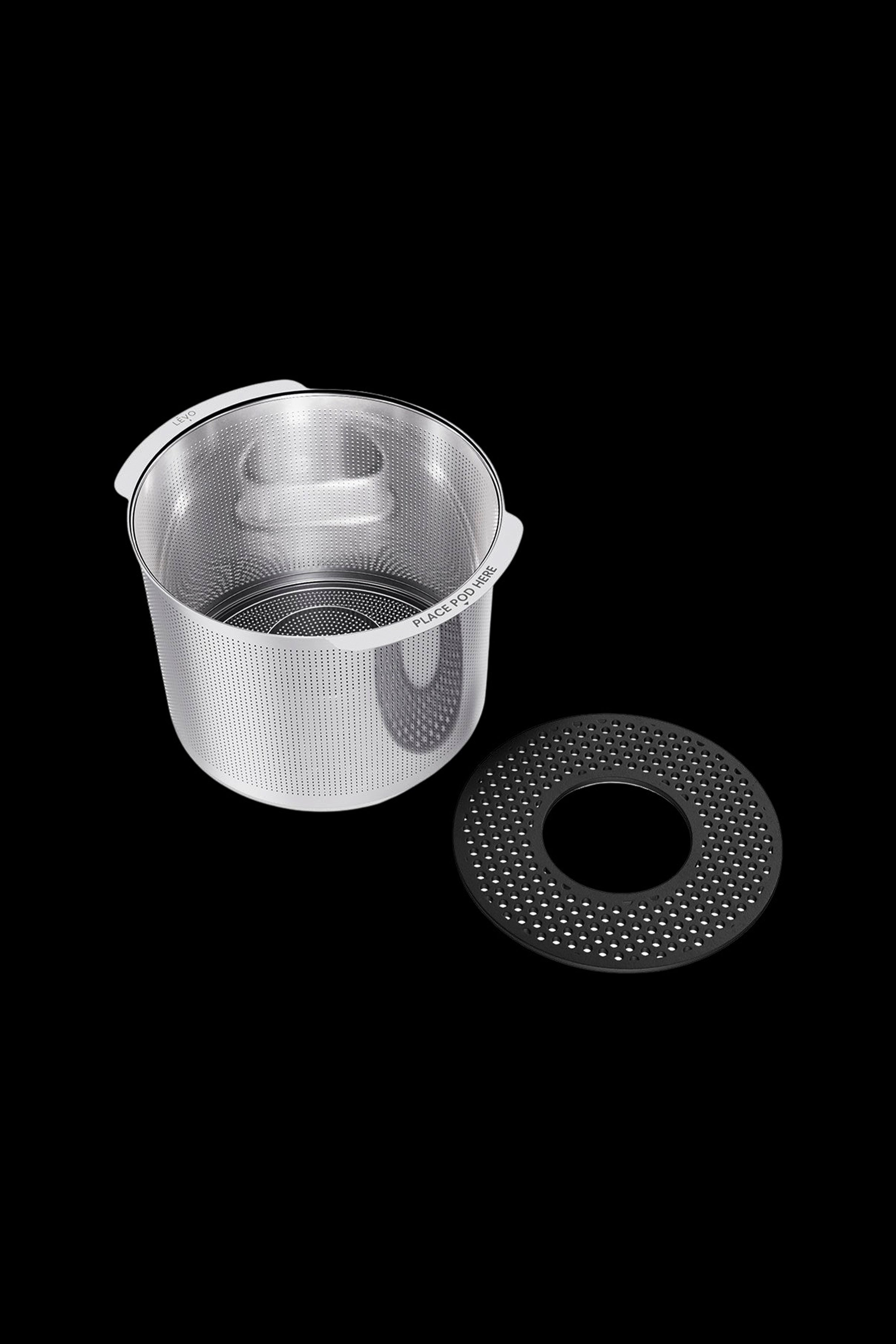 Silver cannabis oil pod and base component against a black background.