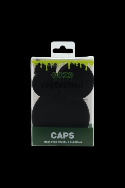Close-up front view of the Ooze Resolution Caps Cleaning Caps in black shown in clear packaging with a green drip logo and "CAPS" label.