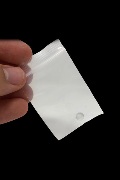 Clear plastic mylar bag held by a hand.