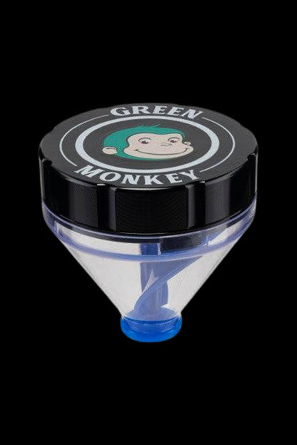Close-up top-down view of a Gold Green Monkey Patas Grinder with its black lid logo showing a smiling green-haired monkey and the clear conical chamber below.