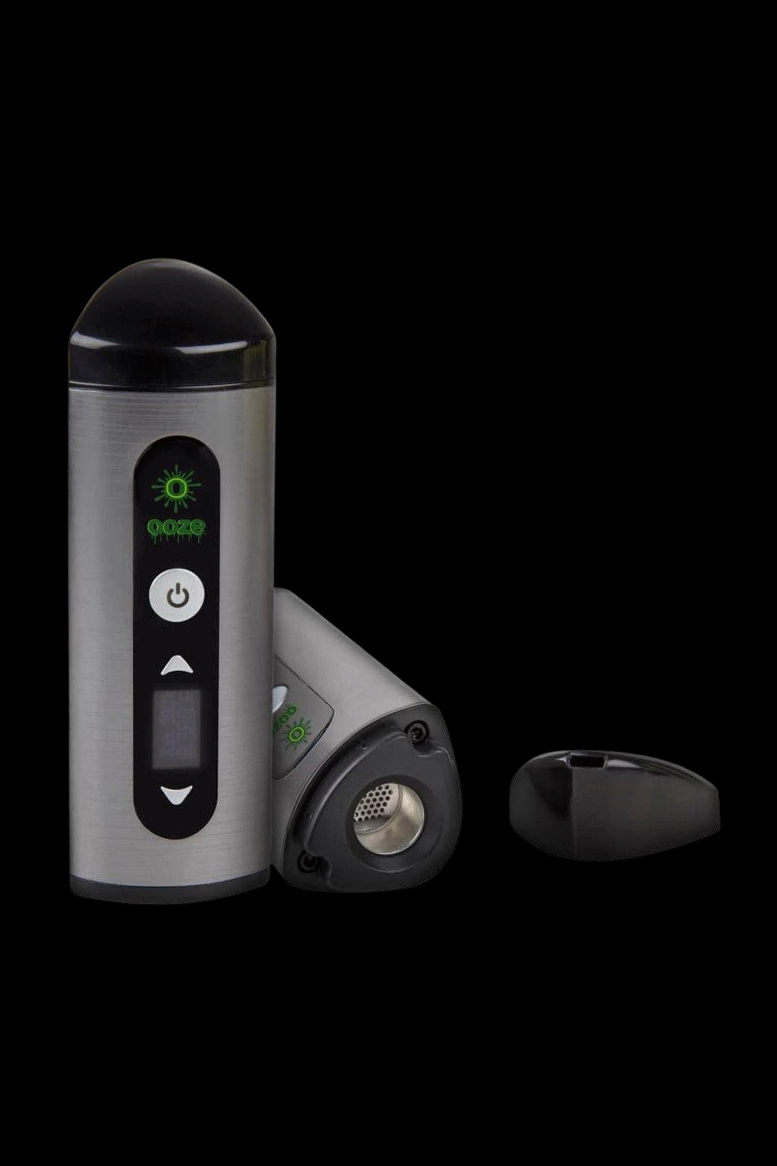 Silver and black cannabis vaporizer with illuminated green controls, displayed with open chamber.