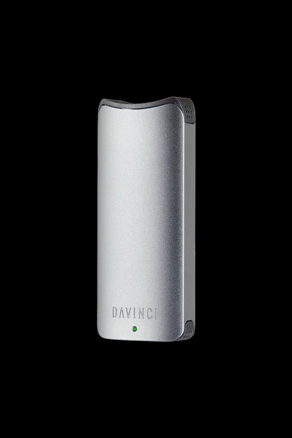 Silver DaVinci IQ2 vaporizer pen against a black background.
