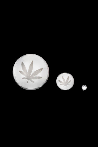 Three polished glass pieces with etched leaf motifs on a black background showing The Stash Shack Carved Leaf Terp Slurper Set.