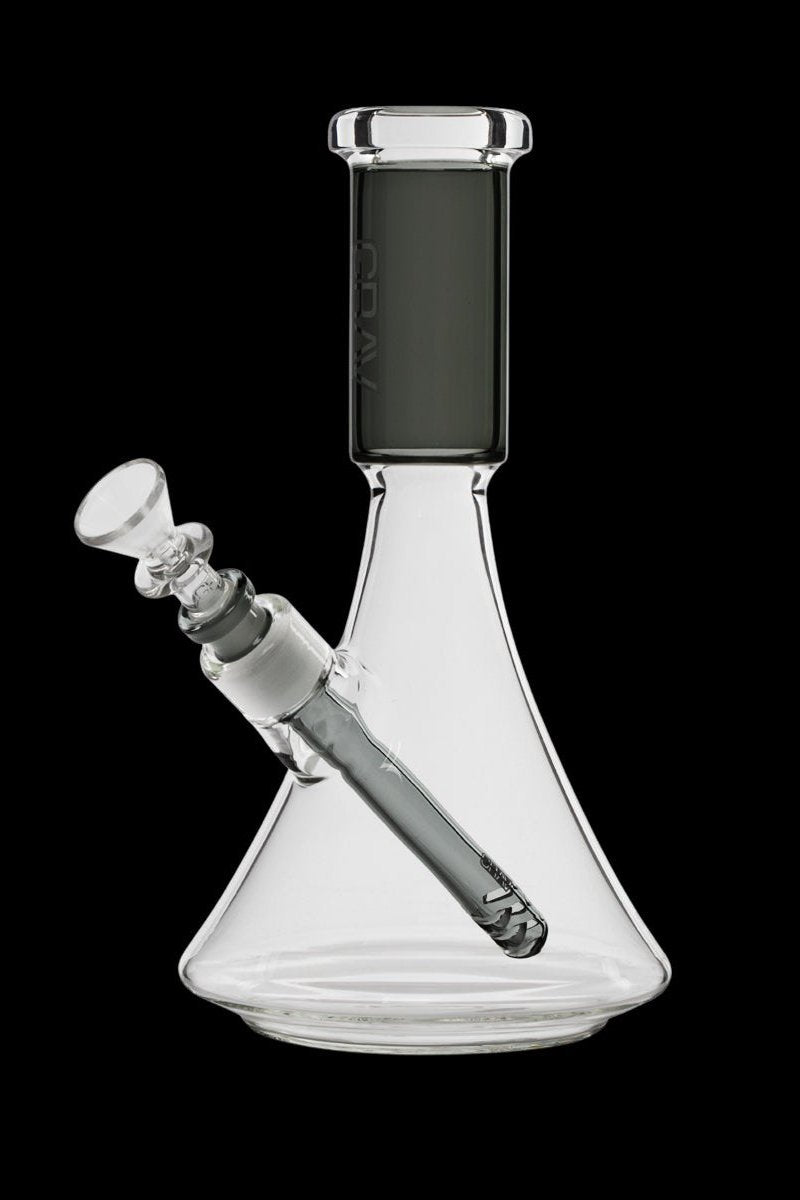 Clear glass beaker bong with a downstem and bowl, isolated on a black background.