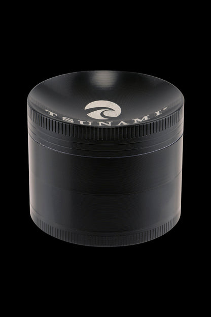 Black metal cannabis grinder with a wave logo on the lid.
