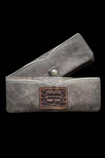 Dark, textured cannabis case with “Original Kawaza” branding, partially open.