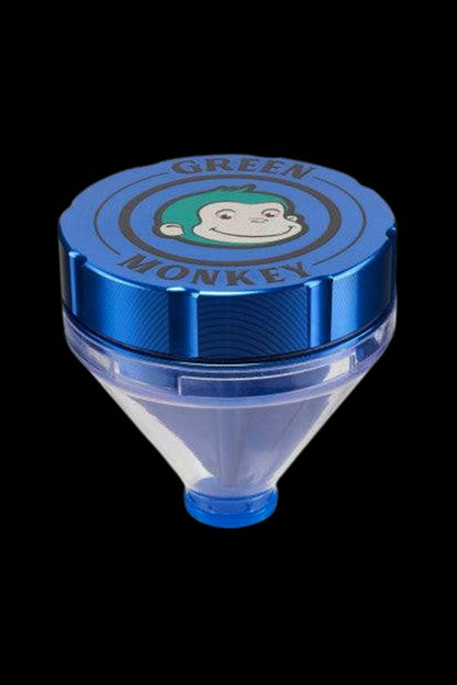 Top-down view of a blue Green Monkey Patas Grinder showing its logo-topped metal lid and clear conical chamber against a black background
