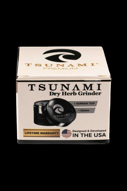 Box for a Tsunami Premium Dry Herb Grinder, featuring a product image and details like "50mm" and "Lifetime Warranty."
