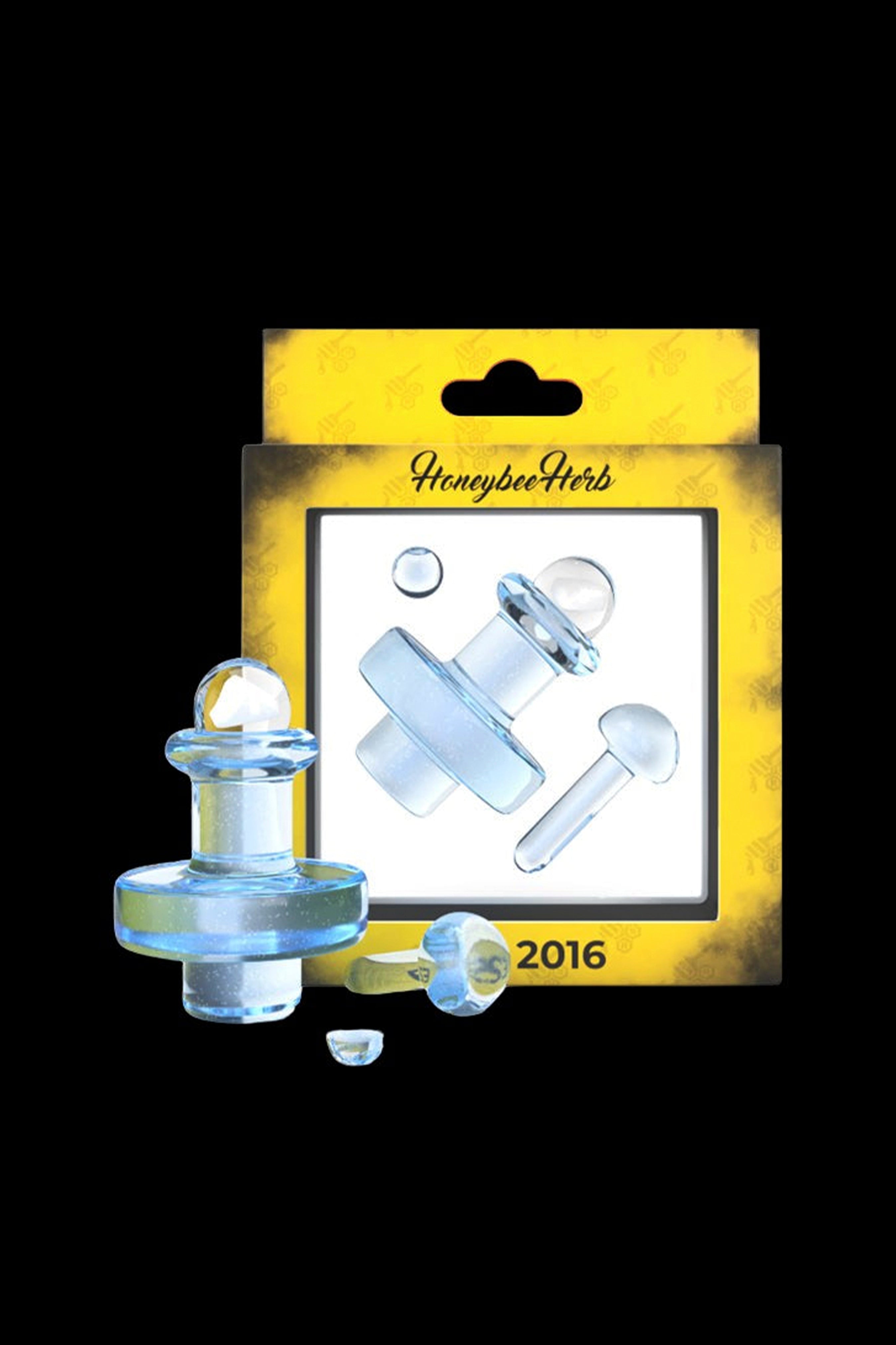 Clear glass dab tool tips and accessories packaged in a yellow cardboard display with “Honeybee Herbs” branding.