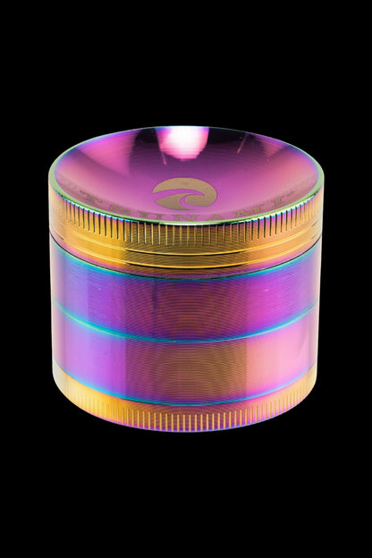 Iridescent metal cannabis grinder with a gold emblem on top.