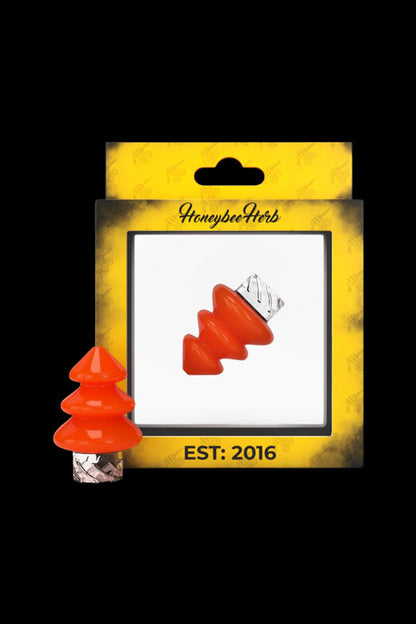 Red cannabis-themed Christmas tree-shaped silicone cap displayed in packaging with “Honeybee Herb” branding and “Est. 2016” text.