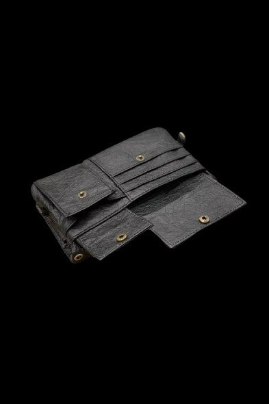 Black cannabis wallet with multiple compartments, open and displayed against a dark background.