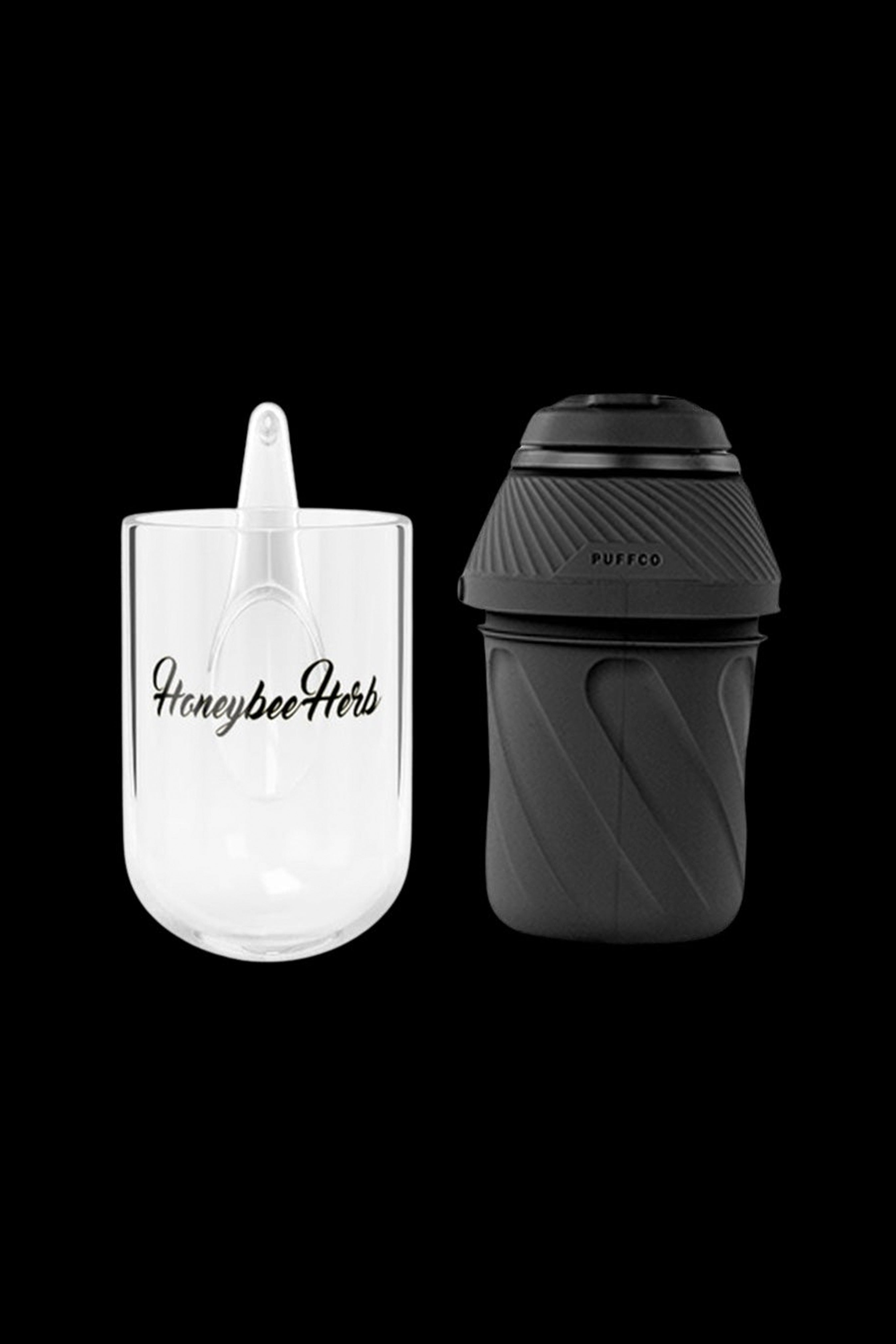 Clear and black cannabis concentrate containers with branded text, isolated on a white background.