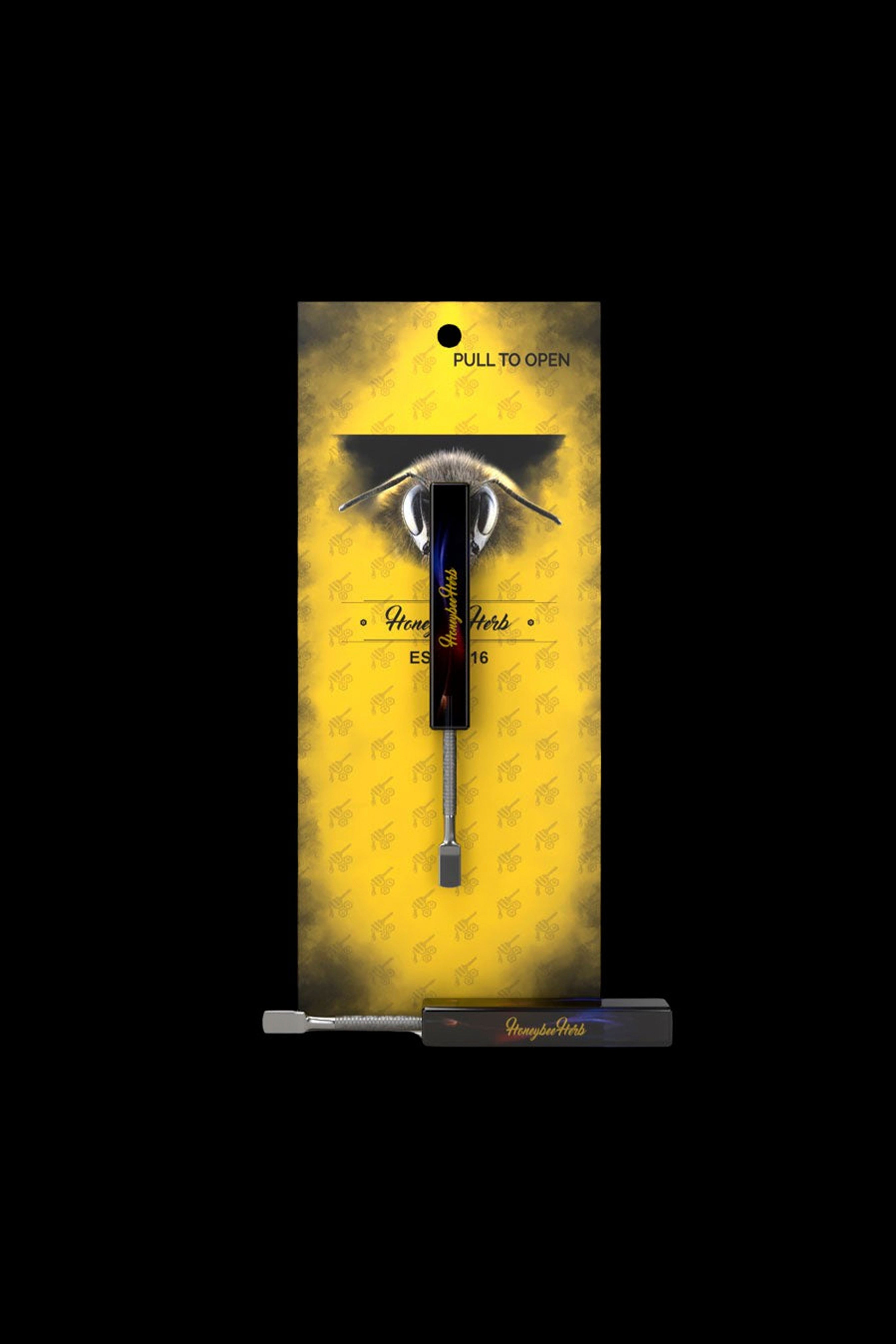 Gold patterned packaging for a cannabis dab tool, branded “HoneyHerb.”